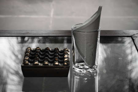 A vintage photo of a smokers table setting at an exotic resortの写真素材