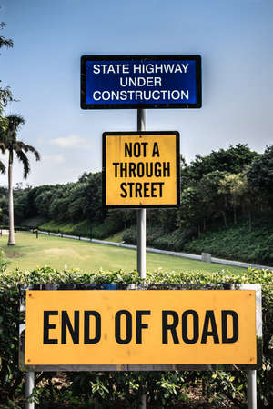 Signage indicating the end of the road and implications of road expansions into the jungleの写真素材