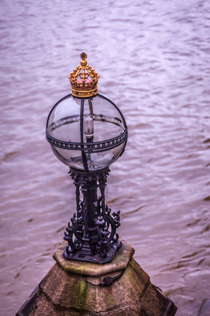 A medieval light post helps light the shoreline for river boatsの写真素材