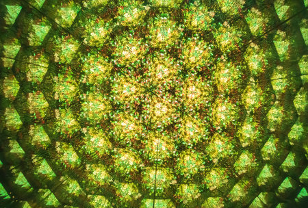 An abstract green background made from looking at a bunch of flowers through a kaleidoscopeの写真素材