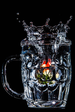 Artistic splash a strawberry created after being dropped into a clear goblet.の写真素材