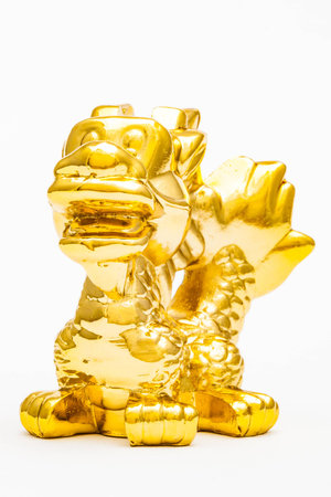Golden figurine of the chinese zodiac sign of the dragon.の写真素材
