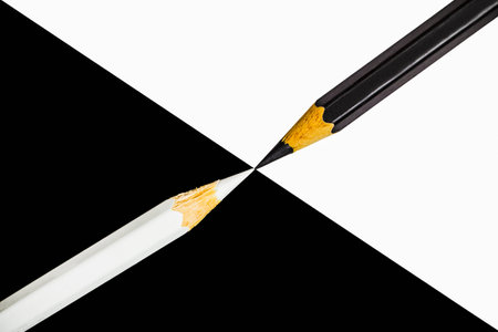 A pair of color pencils in contrasting positionsの写真素材