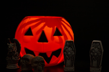 Halloween night scene with Jack O Lanterns, tombstones, skulls and gargoylesの写真素材