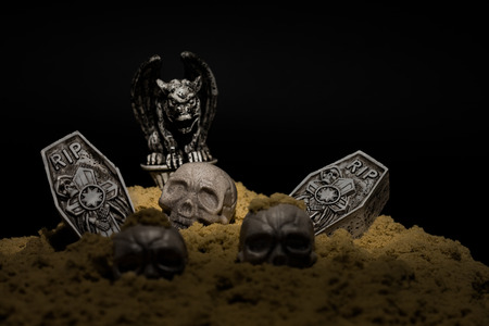 Halloween night graveyard scene with tombstones, skulls and gargoylesの写真素材