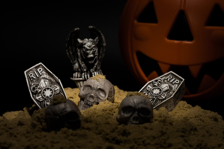 Halloween night scene with Jack O Lanterns, tombstones, skulls and gargoylesの写真素材