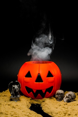 Halloween night scene with Jack O Lanterns, smoke, tombstones, skulls and gargoylesの写真素材