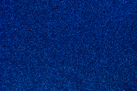 Navy blue colored sand paper textured background with sparkles and glittersの写真素材
