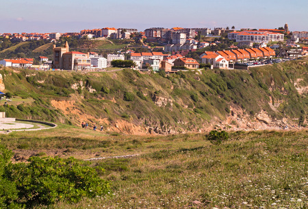 View of the town on the high coast. Spain, suburb of Suances, summer day in the Province of Cantabria, it is photographed from Playa de Los Locos.の写真素材