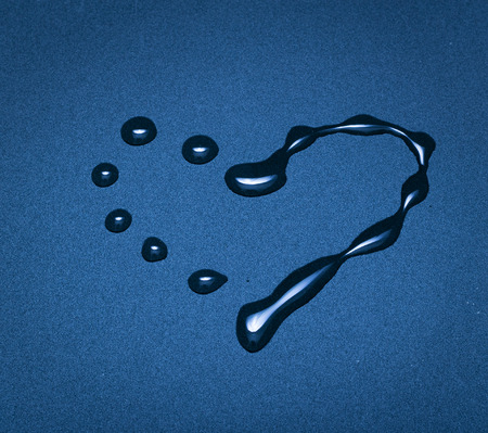 Heart from water drops on a blue background. Close up, small depth of sharpnessの写真素材