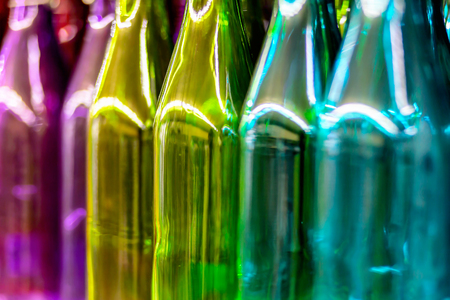 Multicolored glass bottles on the shelf in the store.の写真素材