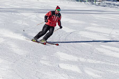 PYRENEES, ANDORRA - FEBRUARY 13, 2019: A skier descends from the mountain at high speed at a ski resortのeditorial素材