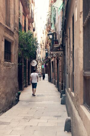ARSELONA, SPAIN - AUGUST 6, 2019:Tourists on the streets of the old city in Barcelona on a sultry summer afternoonのeditorial素材