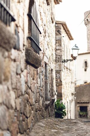 Ancient houses on a medieval street in Europe. Hot summer day, siesta, people on the street is notの写真素材