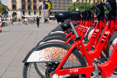 BARSELONA, SPAIN - AUGUST 6, 2019: Bicycles for rent on the street of the city.のeditorial素材