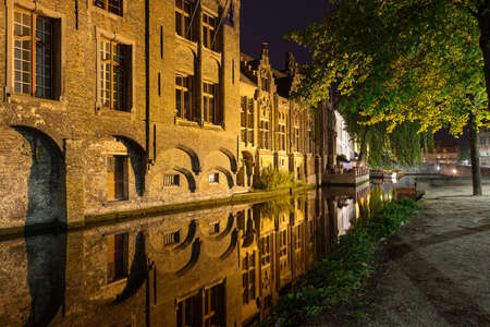 UGES, BELGIUM - JUNE 9, 2017: Ancient buildings in the city centre are reflected in the water of the canals at night.のeditorial素材