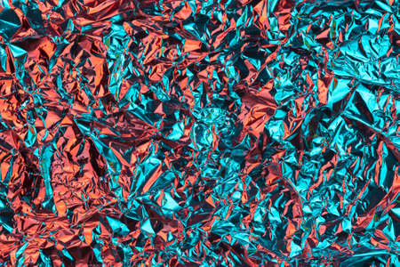 Abstract multicolored background made of crumpled foil.の写真素材