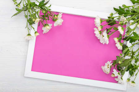 The frame with empty space inside rests on a wooden table.の写真素材