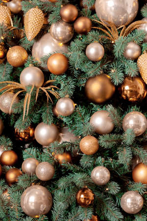 New Year branches of the Christmas tree with golden balls of decorations.の写真素材