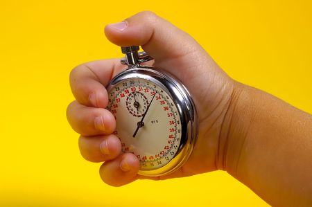 Stopwatch Being Held in a Hand.