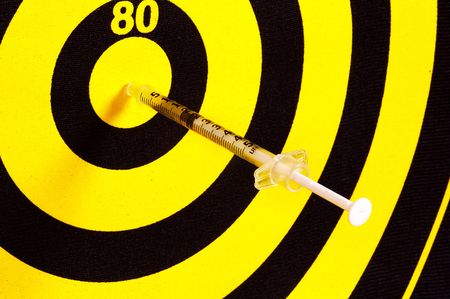 Photo of a Syringe in a Dartboard.  Medical Conceptsの写真素材