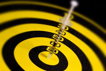 Syringe in a Dartboard.  Medical Related Concept.の写真素材