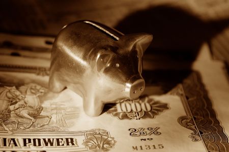Photo of Stock Certificates and a Piggy Bankの写真素材