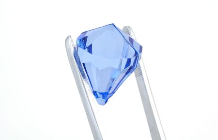Tweezers Holding a Blue Diamondの写真素材