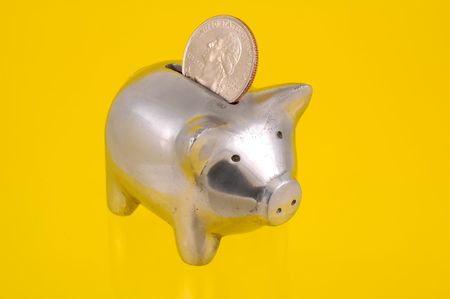 Photo of a Piggy Bank and a Quarterの写真素材