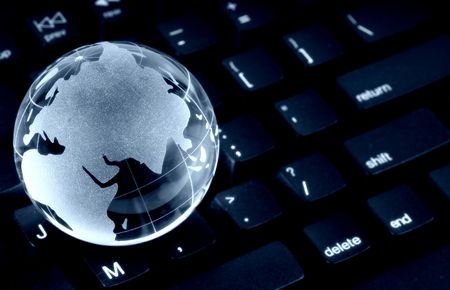 Glass Globe on a Keyboardの写真素材