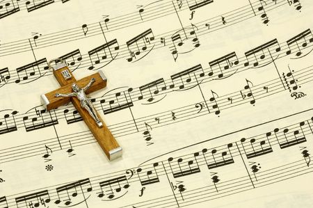 Crucifix on top of Sheet Music