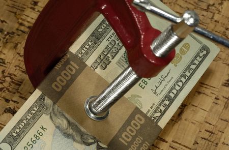 Clamp and Money - Clamping Down on Spending / Budget Conceptの写真素材