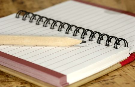 Photo of a Open Notebook with a Wooden Pencl