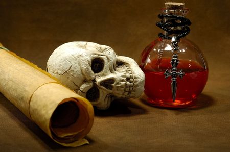 Photo of Parchments, Skull and a Potion Bottle - Magic Spell Conceptの写真素材