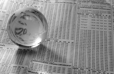 Photo of a Glass Globe on a FInancial Newspaper - Black and Whiteの写真素材