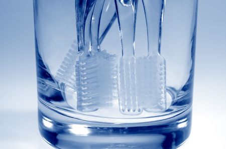 Photo of Toothbrushes in a Glass - Blue Tone - Oral Hygieneの写真素材