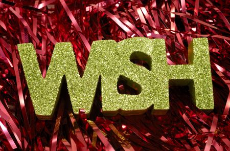 Photo of Red Tinsel and The Word Wish With Green Glitter  -  Christmas Relatedの写真素材