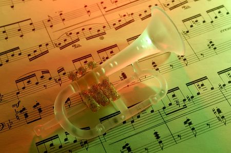 Photo of Sheet Music and a Trumpet Christmas Ornament With Gel Lightingの写真素材