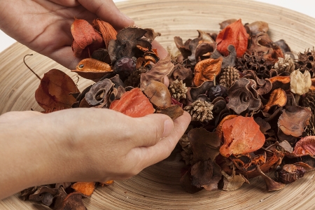 Dried flowers in a big bowl and some hold in handsの写真素材