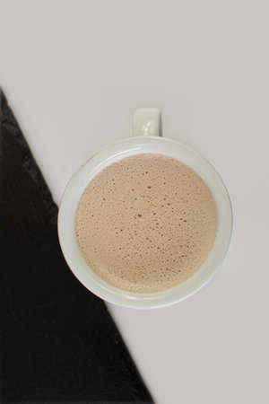 Cup of coffee on a black and white background, top viewの写真素材