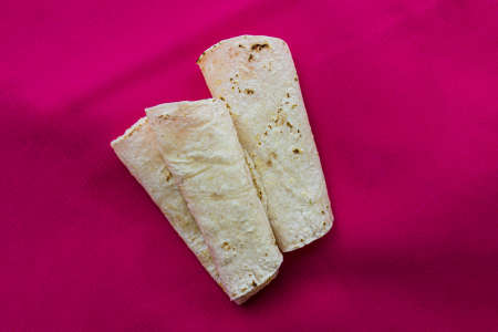Tortilla wraps on a pink background. Top view. Copy space.の写真素材