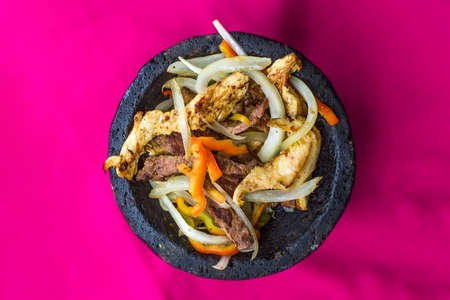 Kebab in a black plate on a pink background. Top viewの写真素材