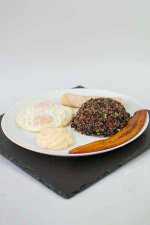 Black rice with fried egg on a white background. Healthy breakfast.の写真素材