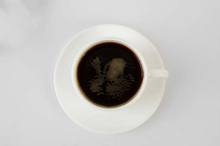 Cup of coffee on white background, top view. Space for textの写真素材