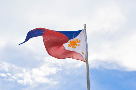 Philippine flag on sky background photoの写真素材