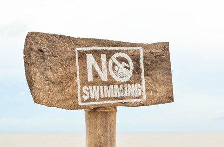No swimming sign at the beach photoの写真素材