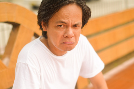 Asian man mad or upset at the park photoの写真素材