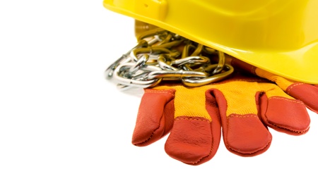 Yellow hard hat, protective gloves and steel chain isolated