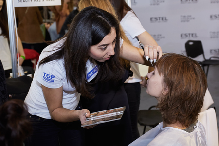 Kyiv, Ukraine - February 4, 2017: Makeup artist at work. Backstage of Ukrainian Fashion Week 2017.のeditorial素材