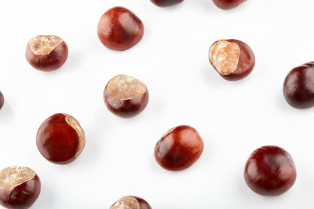 Many peeled chestnuts lie on white background.の写真素材